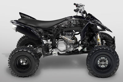 All-terrain vehicle with black and gray camouflage graphics kit on body panels