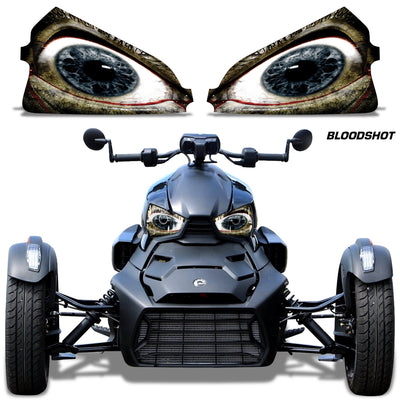 Headlight eye graphics with dark outlines and bluish-gray eyes on a Can-Am roadster front
