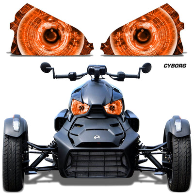 Headlight eye graphics with orange glowing concentric eyes on a Can-Am roadster front