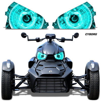 Headlight eye graphics with teal/cyan glowing concentric eyes on a Can-Am roadster front