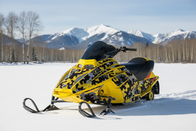 Ski-Doo Mini Z youth snowmobile with Camo Plate graphic wrap kit in open snowy meadow with aspen trees and mountain backdrop